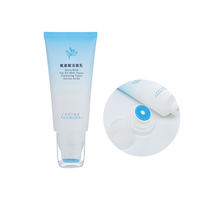Tube cosmétique dégradé bleu mat avec tête de brosse en silicone intégrée pour nettoyant visage