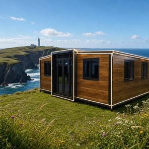 Maison conteneur extensible en planches de bois avec éclairage LED, cadre noir, double aile, vue sur l'océan, cabane de <span class=keywords><strong>falaise</strong></span> côtière, vente en gros OEM - Product Image 1