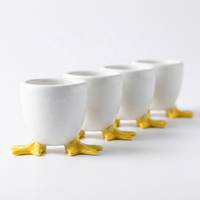 Vente en gros d'œufières créatives en céramique blanche en forme de pattes de canard, porte-œufs amusants en porcelaine en forme d'animaux pour la cuisine, le petit-déjeuner, la décoration de Pâques