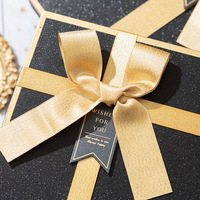 Boîte rigide noire mate premium avec nœud en ruban satiné doré, boîte cadeau de luxe pour les clients d'entreprise