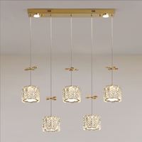 Lustre suspendu moderne de luxe en acier inoxydable avec plusieurs têtes cylindriques, fleurs en cristal doré, pour bar et salle à manger