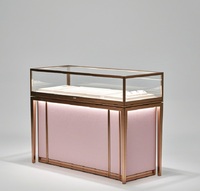 Comptoir de présentation de bijoux GZowin de luxe rose or personnalisable avec éclairage LED, vitrine de vente au détail durable et de haute qualité pour bijoux