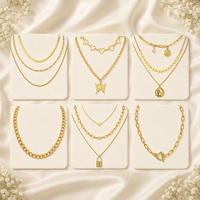 Ensemble de colliers superposés de styles variés avec pendentifs cœur, papillon, pièce de monnaie et cadenas, couleur or et argent, bijoux de mode pour femmes, vente en gros