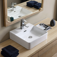 Lavabo de salle de bain moderne en céramique blanche polie avec meuble sous-évier et lavabo artistique intégré au comptoir