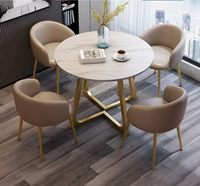 Ensemble table et chaises effet pierre moderne et compact pour réunions d'affaires et réception de clients, usage professionnel en bureau