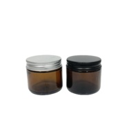 Botol krim kaca amber bulat 2 oz 60ml dengan tutup logam hitam matte untuk makeup Losion eye shadow