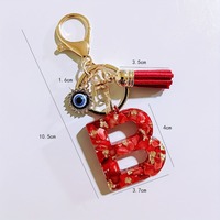 Porte-clés en résine avec initiale A-Z, paillettes dorées, coquille rouge, strass, breloque œil porte-bonheur et pompon rouge, pour femme, cadeau