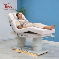 Lit de massage électrique de luxe à 4 moteurs avec commande au pied pour salon de beauté et clinique, avec lumière d'ambiance