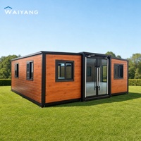 Maison conteneur moderne extensible de luxe 20 pieds avec cadre noir, caractéristiques imperméables et résistantes au vent pour hôtel et bureau