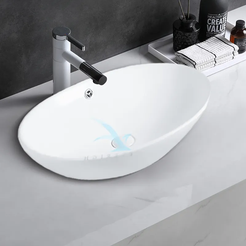 फैक्टरी प्रत्यक्ष बिक्री नॉर्डिक सिरेमिक बाथरूम ओवल सिंक आधुनिक सिरेमिक बाथरूम सिंक व्हाइट वॉश बेसिन