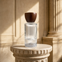 Flacon de parfum de luxe personnalisé en verre cylindrique haut de gamme avec base lourde et bouchon en bois, vente en gros d'usine