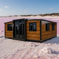 Maison conteneur modulaire extensible en panneaux de bois, à double aile, avec structure noire, Villa vue sur le lac Rose, Vente en gros OEM
