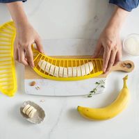 Praktische milieuvriendelijke keukenhulpmiddelen: salade-snijder, ham- en worstsnijder, plastic bananen-snijder, gepersonaliseerde fruitgereedschappen