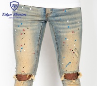 Jean skinny personnalisé en denim déchiré et vieilli, style western vintage, avec éclaboussures de peinture bleue, fabriqué en Chine