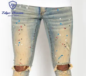 Jeans attillati personalizzati in Denim con bordi strappati strappati Western Vintage Blue Paint Splash Splatters Jeans in Denim fabbrica cinese