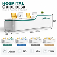 Comptoir d'accueil moderne blanc pour hôpital, avec coins arrondis, bordure verte et plateau de travail haut/bas
