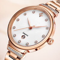 Montre à quartz pour femme, luxe moderne, directement de l'usine, avec verre, bracelet en acier inoxydable, lunette sertie de diamants, aiguilles en forme de feuille, date et fermoir papillon
