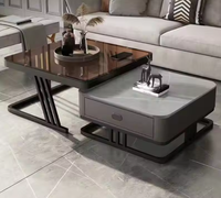 Table basse moderne de luxe avec plateau relevable en pierre frittée, tiroir de rangement et structure en métal noir pour salon