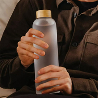 Bouteilles d'eau en verre borosilicaté de 1 litre 550ml 18oz 25oz 32oz personnalisées durables et écologiques portables avec manchon et couvercle en bambou