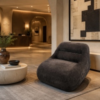 Fauteuil lounge individuel moderne en velours texturé marron foncé, sans accoudoirs, avec housse amovible et coussin lombaire, idéal pour salon ou maison d'hôtes