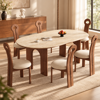 Table à manger ovale contemporaine en travertin, avec pieds en bois de frêne cintrés et plateau en pierre frittée, pour une décoration intérieure élégante
