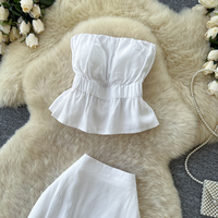 Ensemble deux pièces élégant pour femme : haut bustier peplum et jupe longue taille haute, coupe ajustée, idéal pour le quotidien