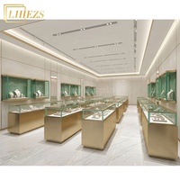 Elegante Weiß-Goldene LED-Schmuckvitrinen Freistehende Schmuck-Ausstellungsvitrine