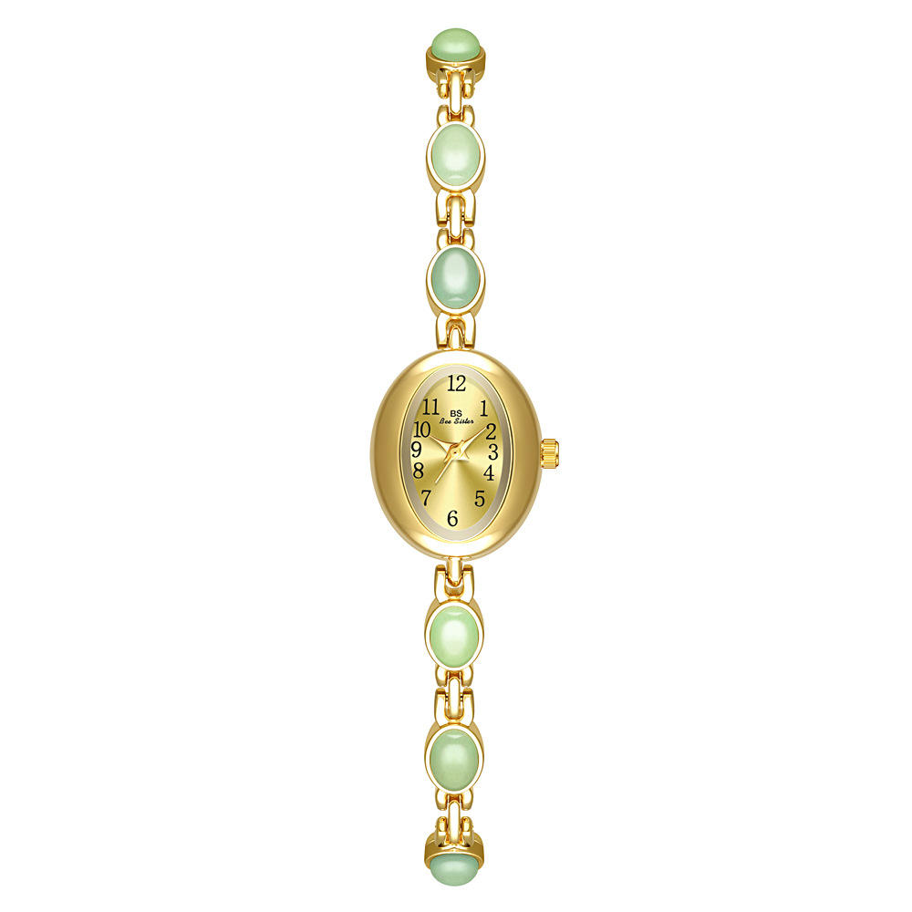 Gold with green stone