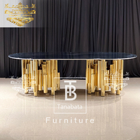 Table et chaises de salle à manger de luxe 12 places base en acier inoxydable doré avec plateau en verre noir