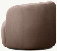 Chaise à dossier arrondi, formes fluides et élégantes, proportionnement confortable, inspirée de la couture artisanale