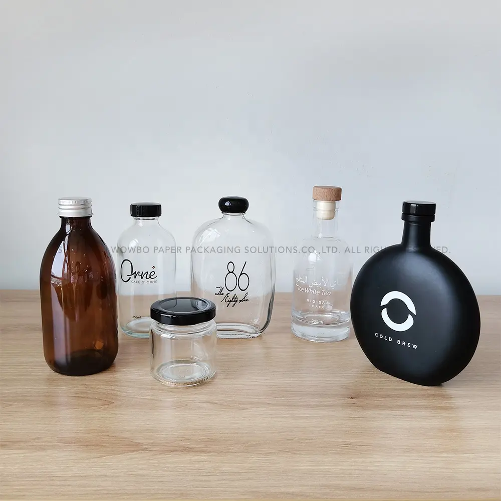 Fábrica al por mayor mejor precio diseño personalizado Impresión de grado alimenticio hermético Paquete de bebidas para llevar botellas de vidrio transparente