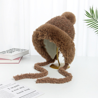 Vente en gros de fil de coton épais et chaud pour protéger les oreilles mentonnières doublées coupe-vent en fourrure de laine pour l'extérieur bonnets d'hiver à pompon pour femmes