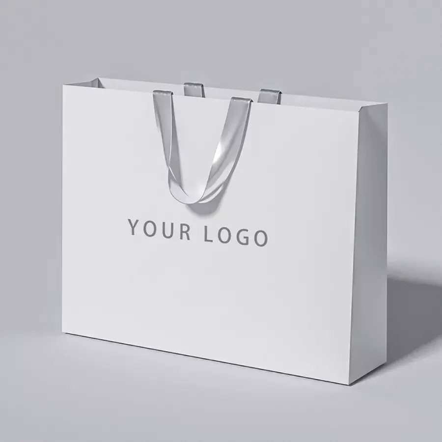 Sac en papier à provisions de marque de luxe avec impression personnalisée de votre propre logo pour cosmétiques vêtements chaussures cadeaux sac de boutique avec poignée en ruban