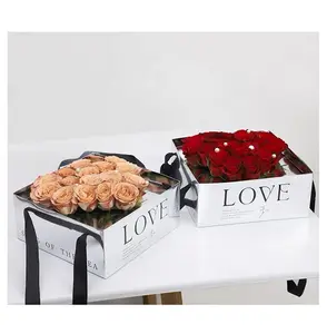 กล่องสีชมพูรูปหัวใจพร้อมหูหิ้วกล่องกระดาษแข็งสำหรับใส่ดอกไม้กุหลาบสำหรับใส่ช่อดอกไม้ที่มีหน้าต่างใส