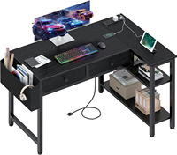 Bureau de jeu en forme de L réversible noir avec tiroirs, étagères de rangement, prise de courant, bureau d'angle pour ordinateur personnel pour la chambre des garçons