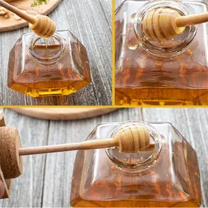 L'esagono piano 220ml ha sigillato i barattoli di vetro del miele 350g con il coperchio di legno della copertura dello mestolo del miele