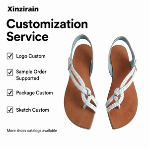 Xinzirain レディース フラットサンダル 編み込みストラップ メタルリングバックル トングサンダル クロスストラップ - Product Image 1