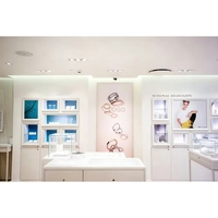Kiosque à bijoux moderne pour centre commercial, lustre artistique personnalisé en forme d'oiseau, comptoir de réception en marbre, design intégré pour façade intérieure