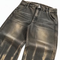 Celana Jeans Denim Abu-abu Tua dengan Model Kaki Balon yang Santai, Efek Whisker Horizontal, dan Aksen Abrasi di Bagian Bawah Kaki