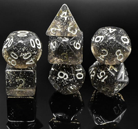 Dés polyédriques noirs mouchetés d'étoile de résine avec la numérotation blanche pour des jeux de rôle de table