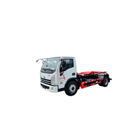 Camion compacteur à bras hydraulique SAIC Yuejin Blue Label Diesel Euro 3 avec benne à ordures interchangeable pour le transfert de déchets