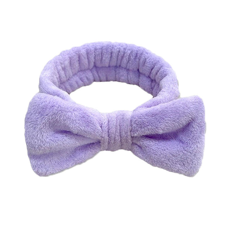 Diadema morado oscuro con lazo.