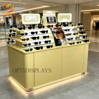 Exhibidores de Gafas con Marco Óptico Naranja Vibrante, Base LED Brillante, Estantes de Vidrio Templado Escalonados, Soporte para Exhibición de Gafas