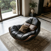 Fauteuil de loisirs individuel en cuir noir avec cadre en fibre de verre noir, coussin moelleux, idéal pour les espaces de vie modernes aux tons sombres