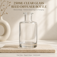 Flacon cylindrique élégant en verre transparent de 250 ml avec logo personnalisé et impression sérigraphique pour le stockage d'huiles essentielles et de parfums