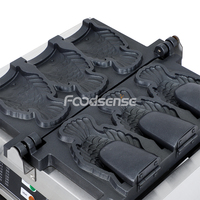 Machine commerciale de gaufrier de plaque en forme d'animal de double secousse Machine de casse-croûte Taiyaki de dinosaure de bouche ouverte personnalisée