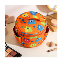 Sac cosmétique rond à poignée supérieure, imprimé monstre coloré, poches latérales, organiseur de maquillage pour les voyages et l'usage quotidien