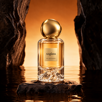 Flacon de parfum cylindrique de luxe en verre avec base sculptée en forme de montagne, bouchon en galet doré, sérigraphie, 30ml 50ml 100ml pour parfum