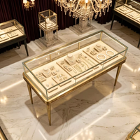 Vitrine de présentation de bijoux en métal doré antique avec pieds, comptoir en verre éclairé pour boutique de joaillerie haut de gamme