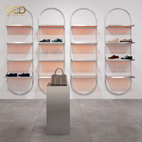 Porte-vêtements mural moderne en chrome personnalisé avec étagères pour boutique de vente au détail